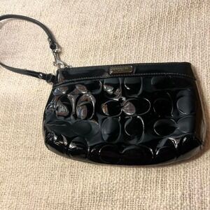 black Coach signature debossed patent leather wristlet